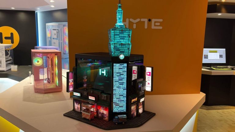 This skyscraper-shaped custom PC at Computex has a food stall out the front selling ‘Taiwanese sausage with sticky rice’ and a rock climber free soloing up the side